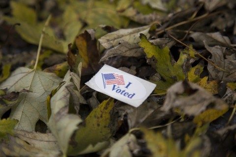 I Voted sticker lying on the ground on top of dead leaves