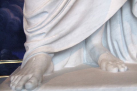 feet of a statue of Jesus