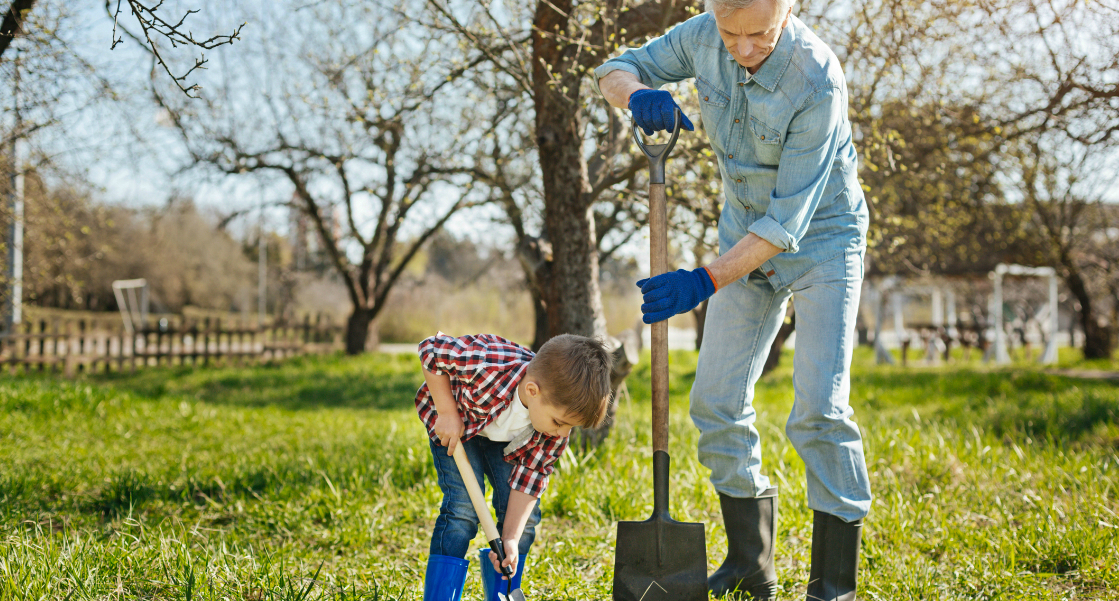 Boy and older man planting