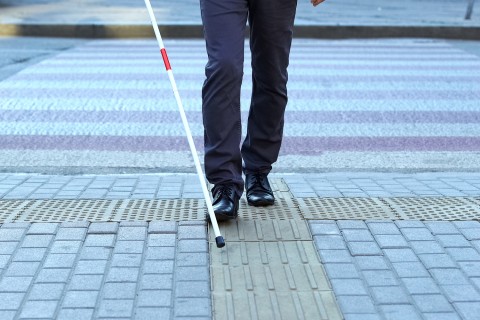 man's legs walking with cane