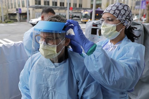 nurses assisting each other with protective gear