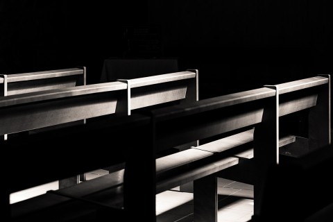 empty pews in the dark