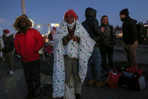 A student covers herself in blanket at the Medyka border crossing in Poland after fleeing from the Ukraine in February.