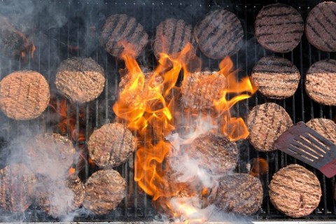 burgers on a fiery grill