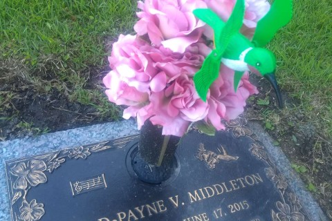 gravestone with a hummingbird decoration