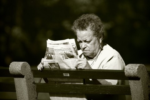 woman reading newspaper