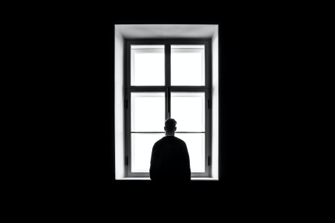 man alone at window