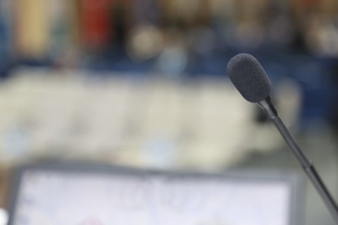 speaking at microphone