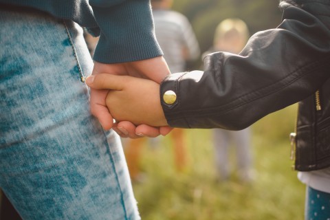 image of mother and child holding hands