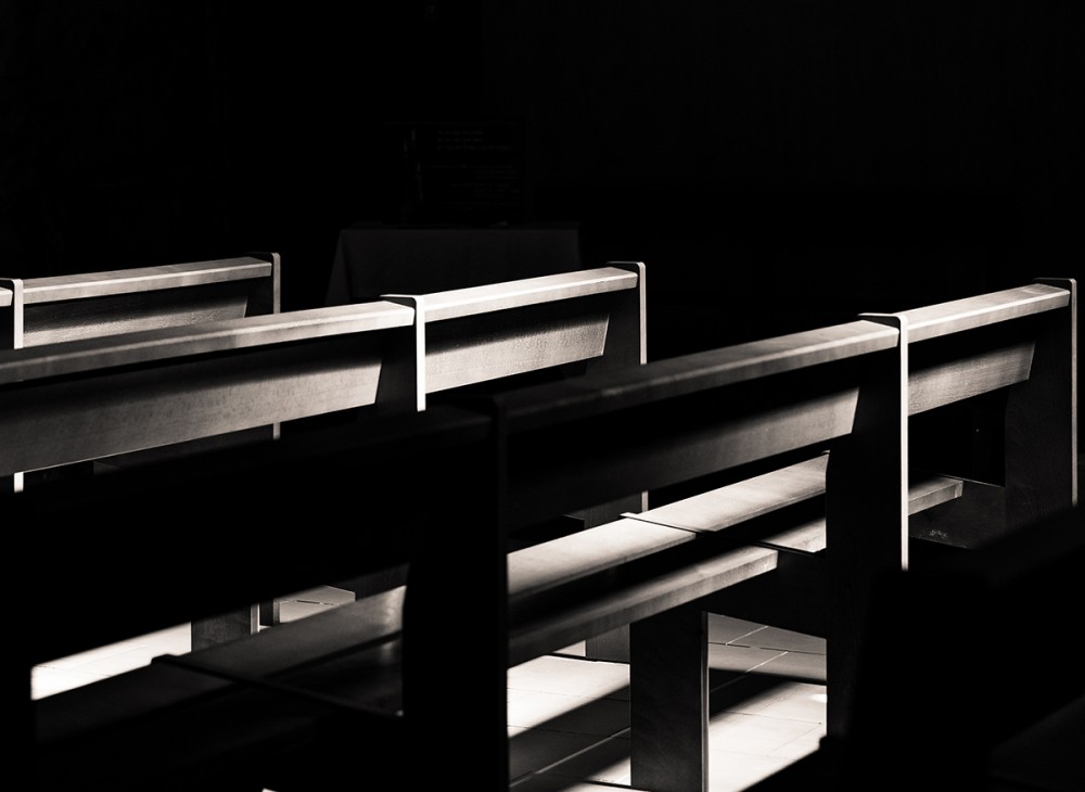empty pews in the dark