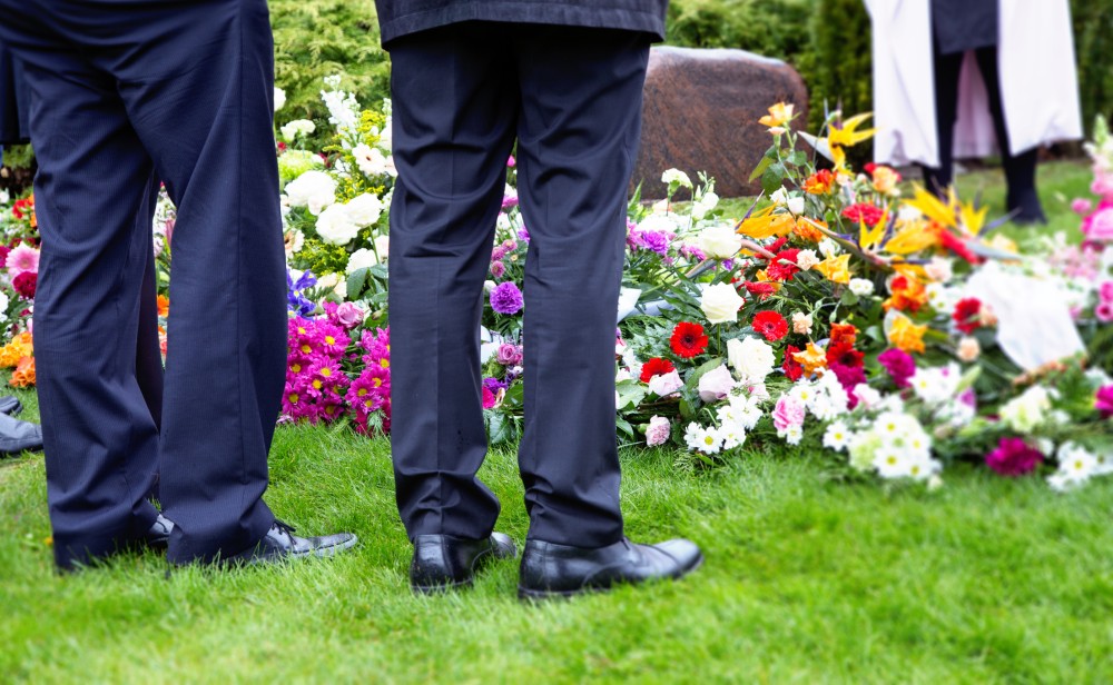 Standing next to a grave