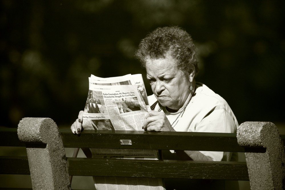 woman reading newspaper