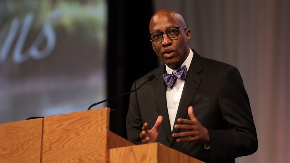 A photo of J. Herbert Nelson speaking at a podium.