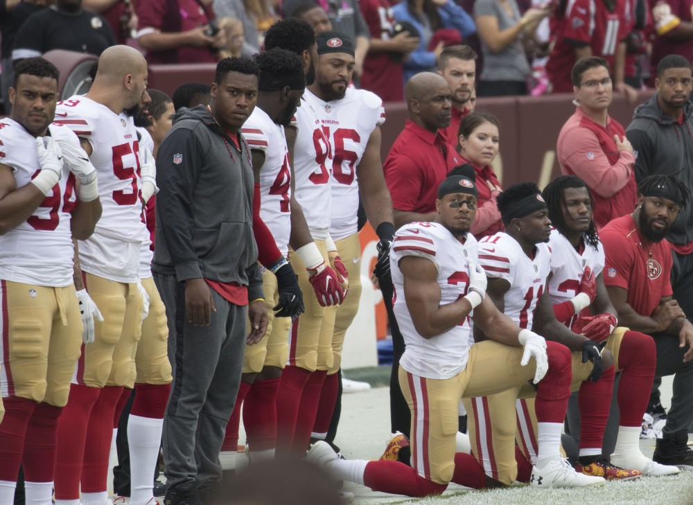 Football players kneeling