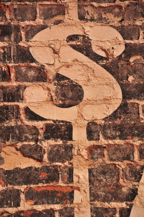 dollar sign on bricks