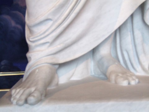 feet of a statue of Jesus