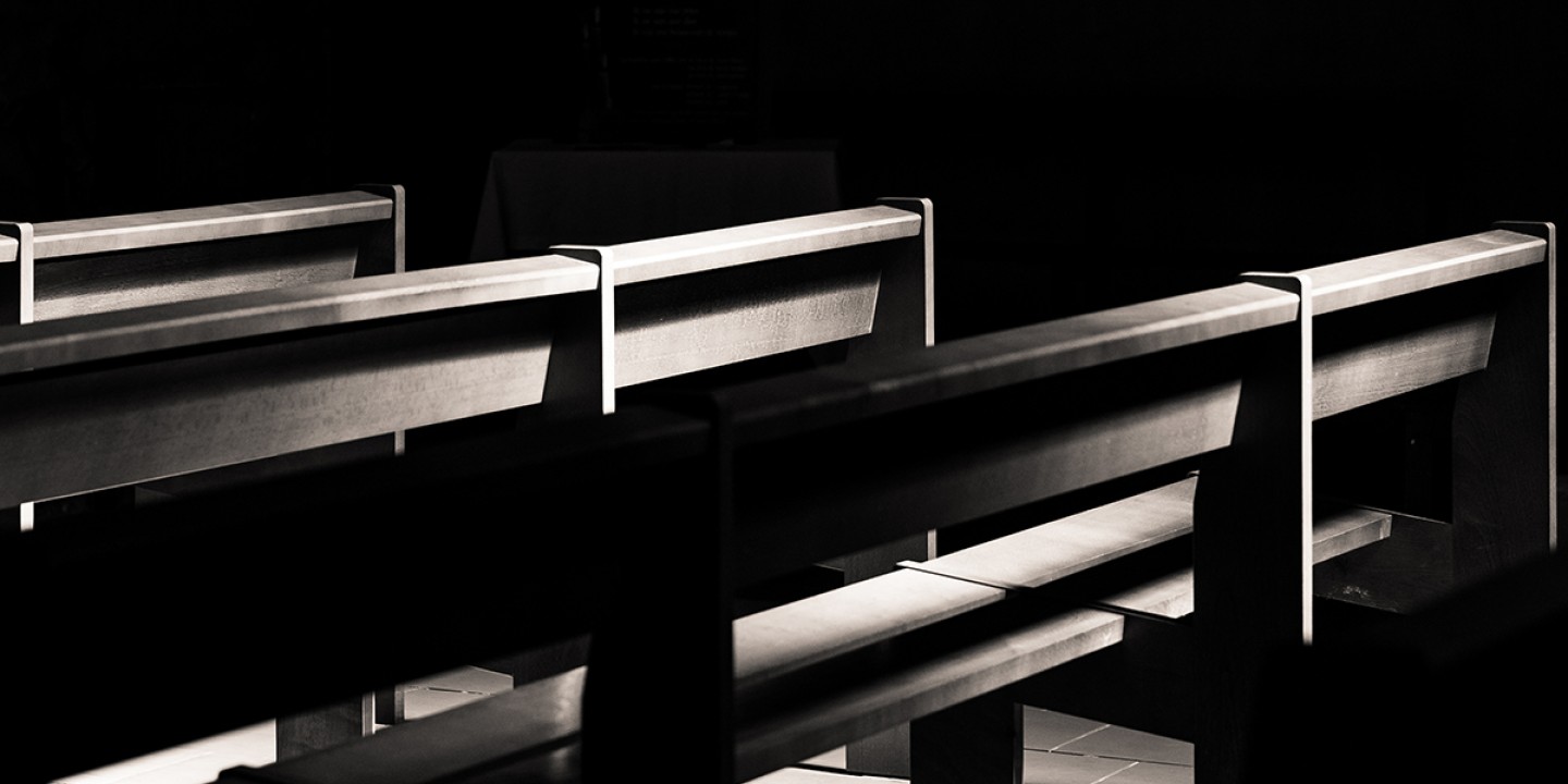 empty pews in the dark