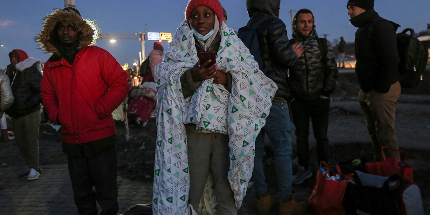 A student covers herself in blanket at the Medyka border crossing in Poland after fleeing from the Ukraine in February.