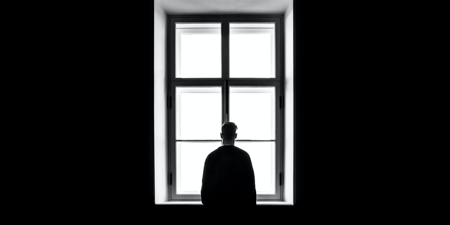 man alone at window