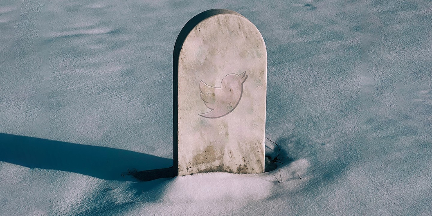 a headstone in a snowy graveyard features the iconic Twitter bird