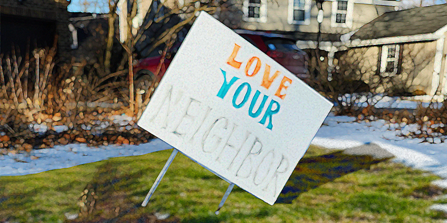 A worn yard sign that says "Love your neighbor"