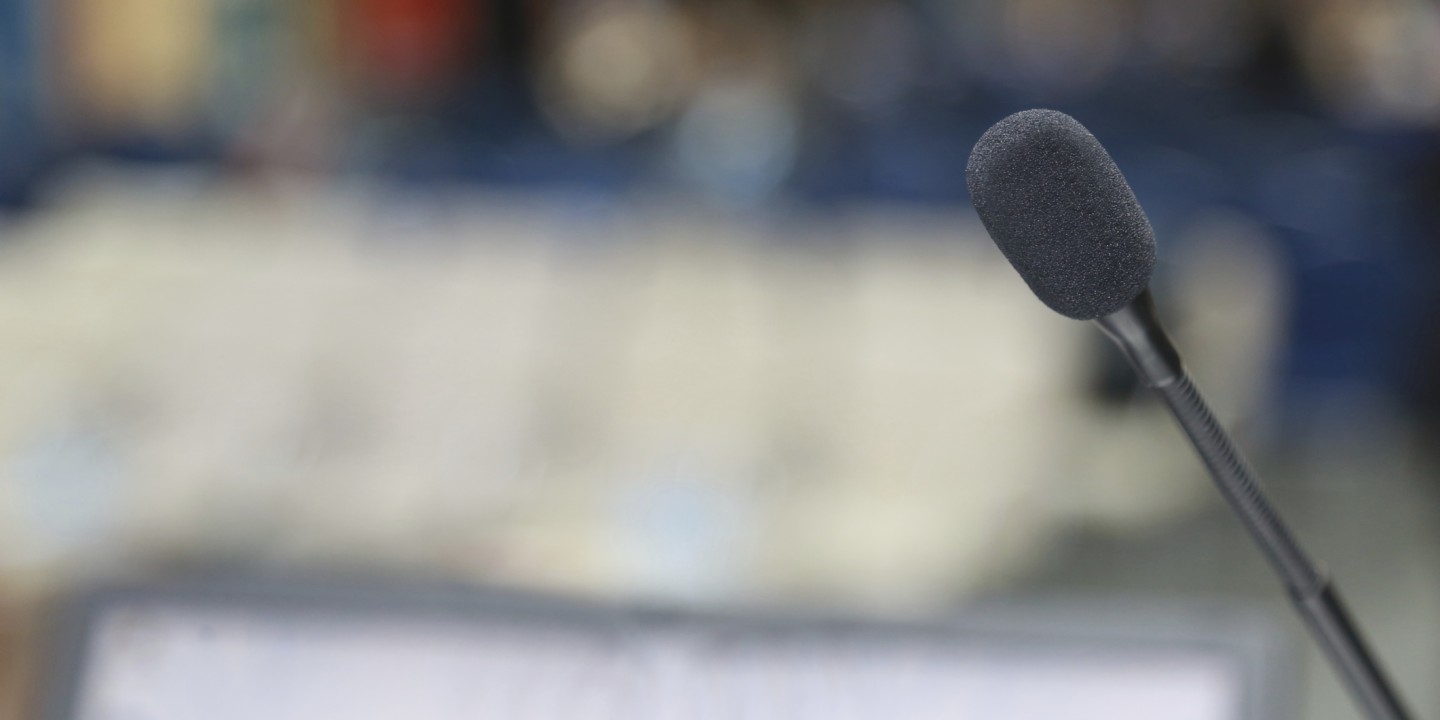 speaking at microphone