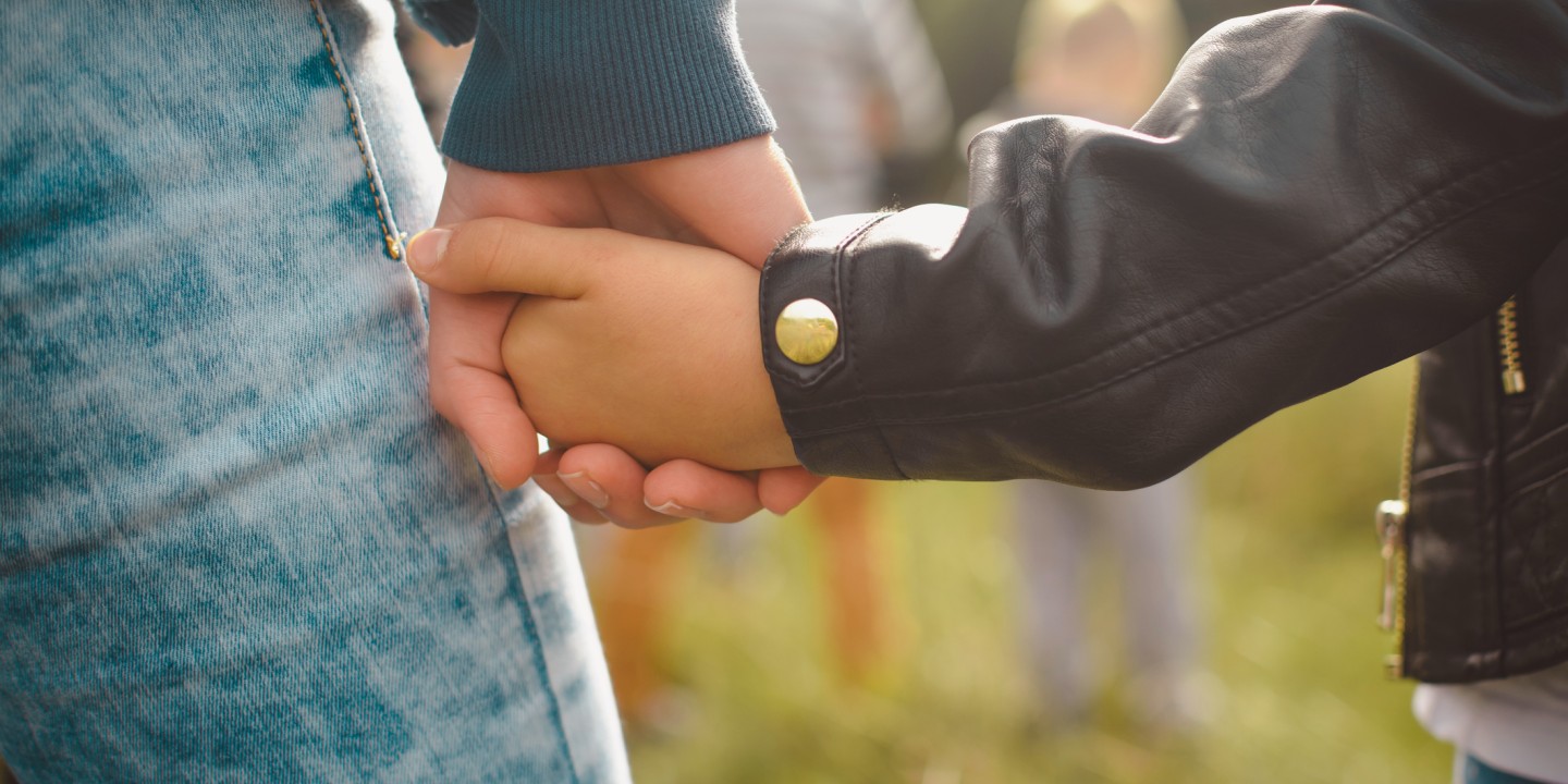 image of mother and child holding hands