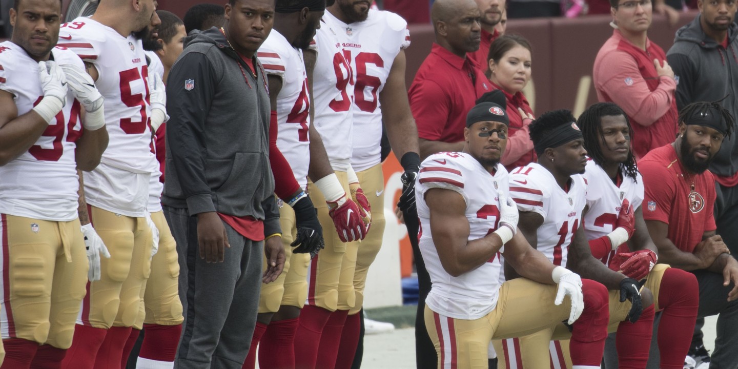 Football players kneeling